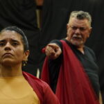 Atores em cena durante apresentação teatral